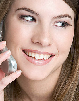photo of a smiling young woman talking on the phone